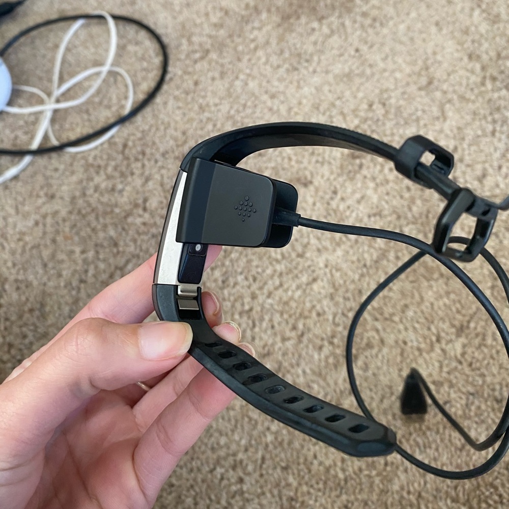 Black Fitbit charge (2017) with charger